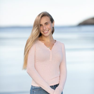 High School Senior portrait. Using natural light in a fashion inspired style. Beach and ocean in background. Beautiful soft pastels.