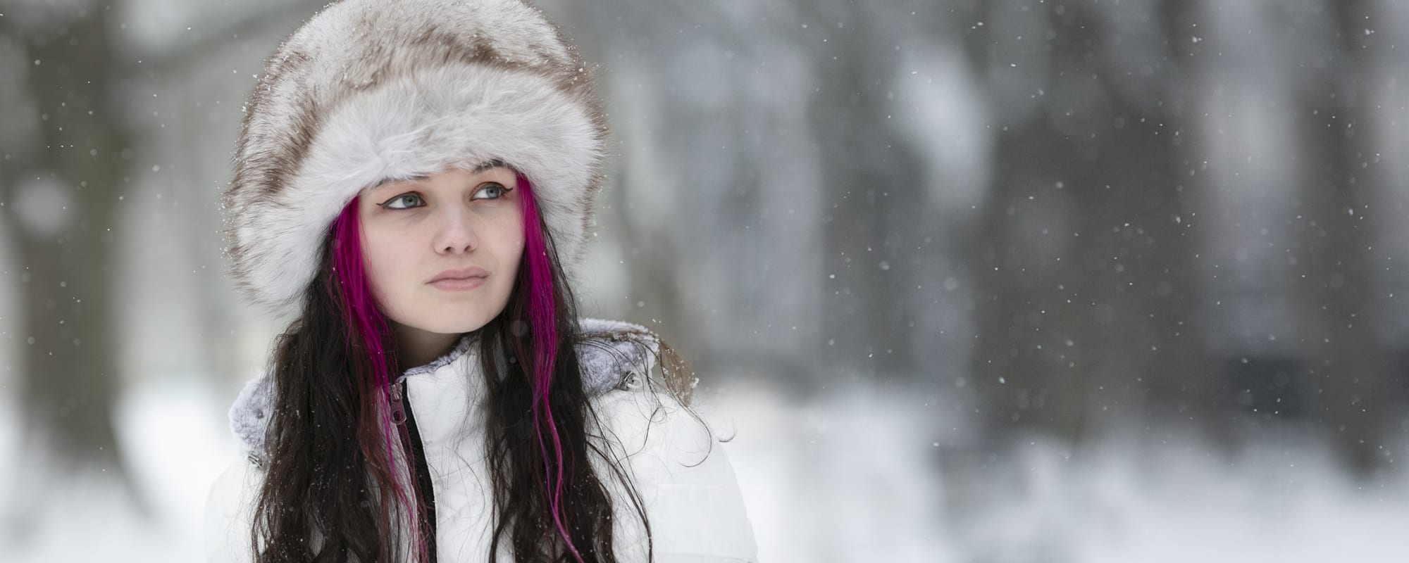 Fur hat girl in snowfall